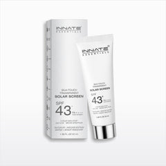 INNATE ESSENTIALs Silk-Touch Transparent Solar Screen SPF 43+ sunscreen in a white squeeze tube with a silver cap, shown next to its white packaging box on a light gray background.